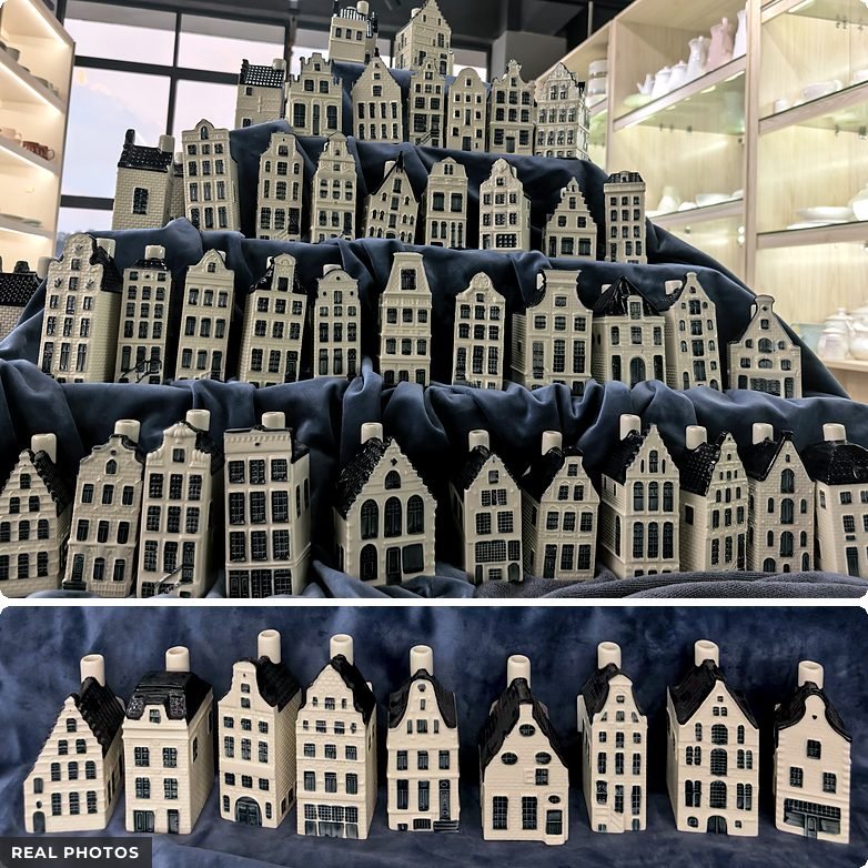 Real photos: rows of Delft Blue miniature ceramic canal houses on a tiered display in a ceramics manufacturer's showroom